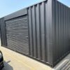 518319815_24084520591203501_6401163788766369853_n.jpg 20ft Used Shipping Container – Matte Black w/ 12’ Side Roll-Up Door